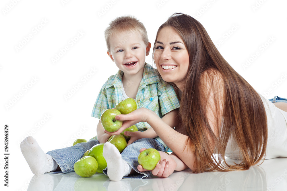 Fototapeta premium Mother with son are eating apples in studio