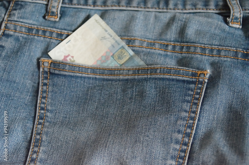 jean pocket with a partly seen Ukrainian banknote