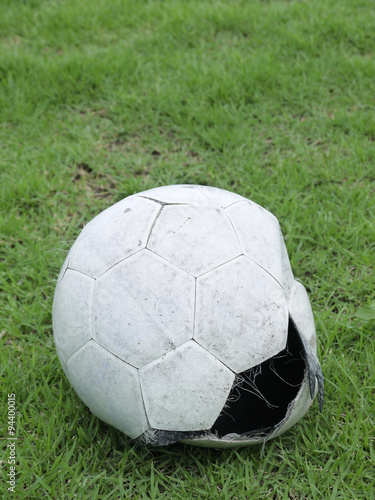 worn ball on the grass