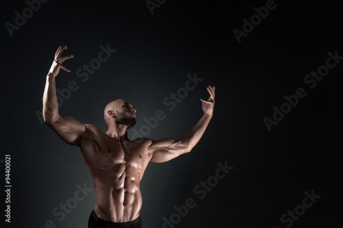 man posing in the studio on a dark background