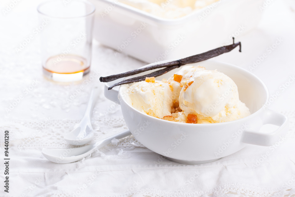 Vanilla ice cream with candied oranges on a white background for Christmas. Vanilla ice cream with candied oranges on a white background for Christmas.