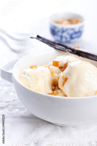 Vanilla ice cream with candied oranges on a white background