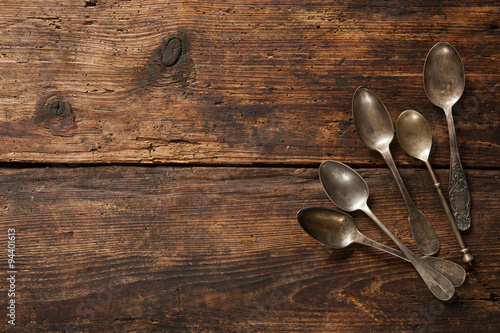 Metal spoons on wooden table