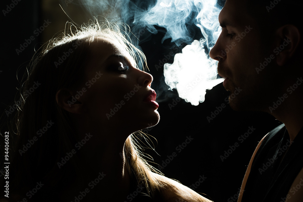 Couple puff smoke into face