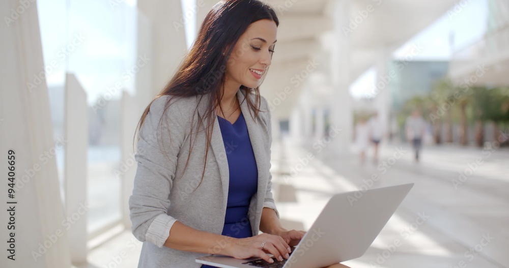 Businesswoman relaxing and working on a laptop Businesswoman relaxing and working on a laptop