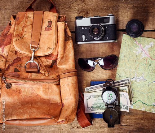 travel equipment -  map, backpack, vintage camera, sunglasses, compass, passport and money