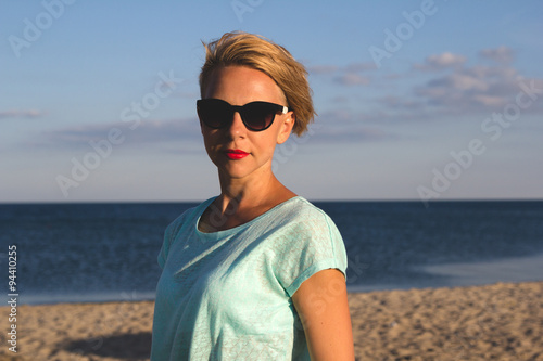 Portrait of beautiful blonde woman on the summer beach