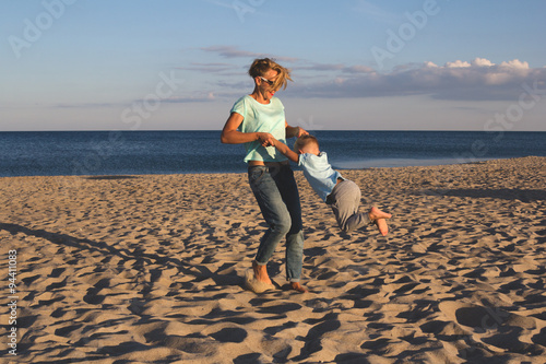 Happy family resting at beach in summer photo