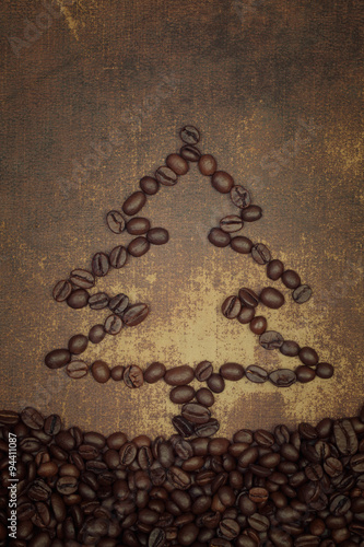 A christmas tree out line made out of  roasted coffee beans on s