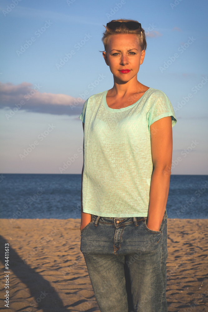 Portrait of beautiful blonde woman on the summer beach