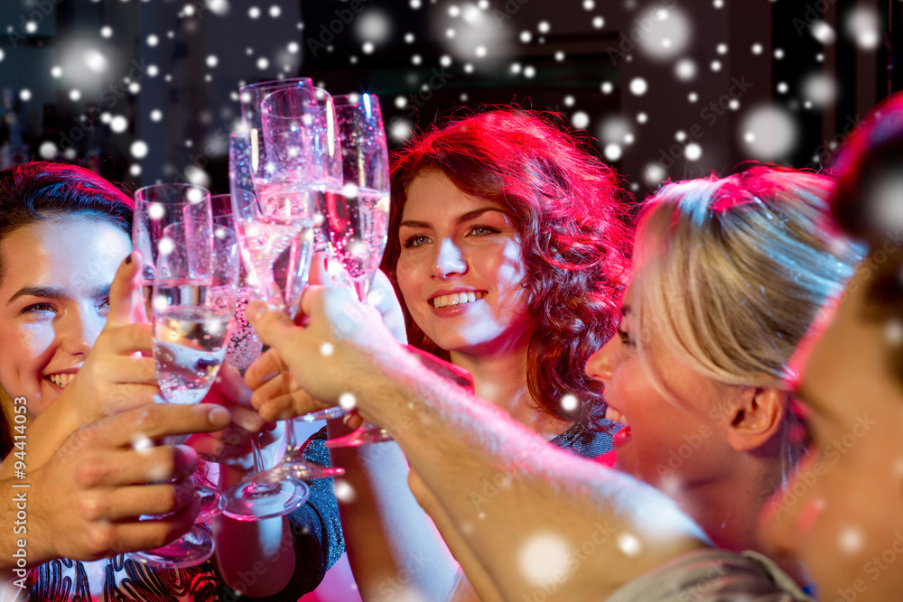 smiling friends with glasses of champagne in club smiling friends with glasses of champagne in club
