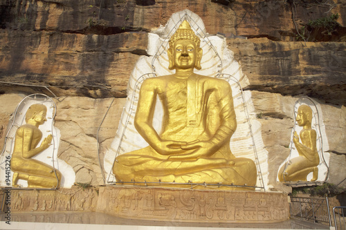 golden buddha on sandstone cliff,Banphu homestay North east Thailand