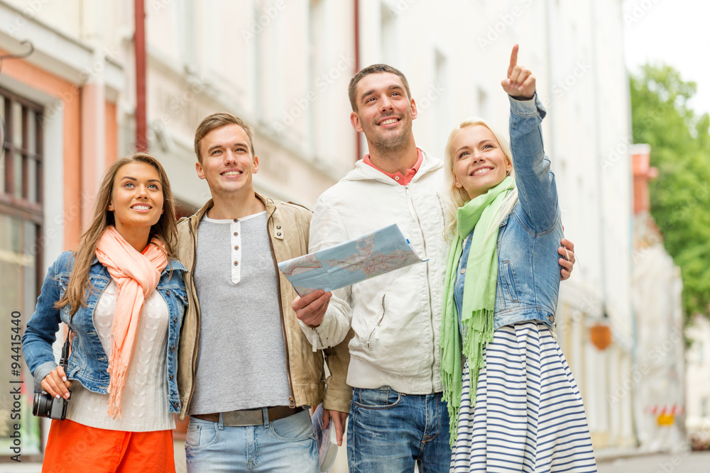 Fototapeta premium group of smiling friends with map and photocamera