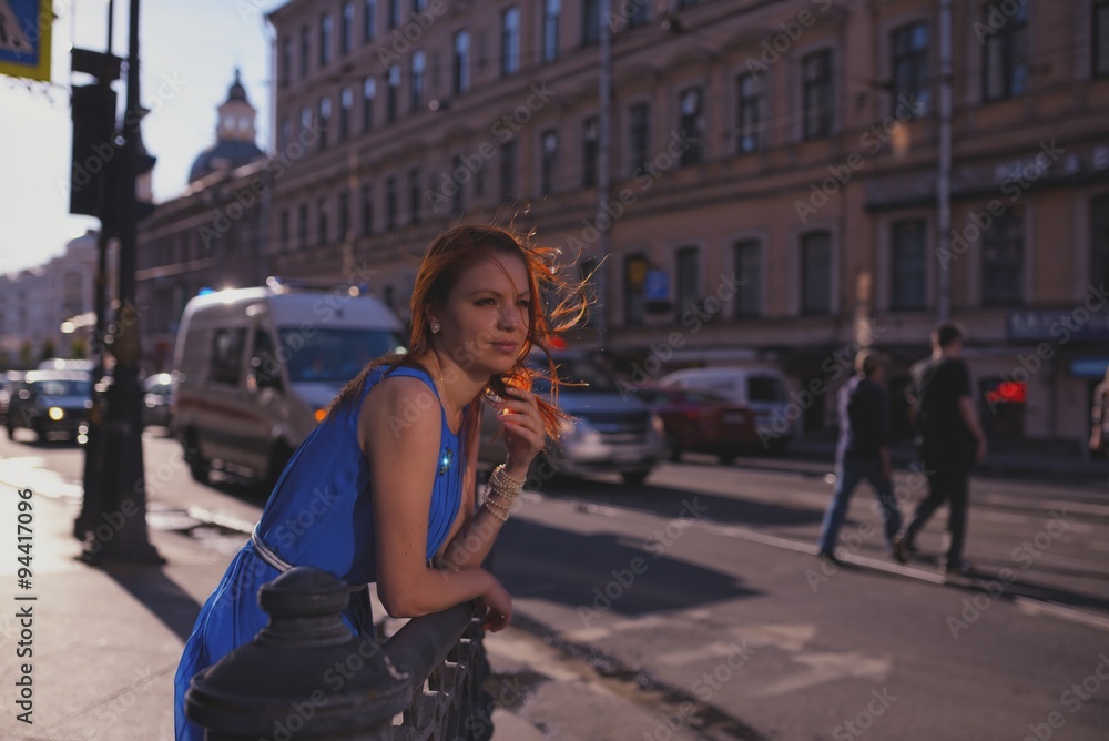 Outdoor portrait of young beautiful caucasian woman walks on street in St.Petersburg, Russia