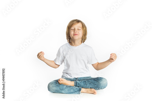 Boy sitting. Yoga. Lotus Position.