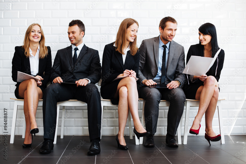 Group of happy business people sitting in waiting room Group of happy business people sitting in waiting room