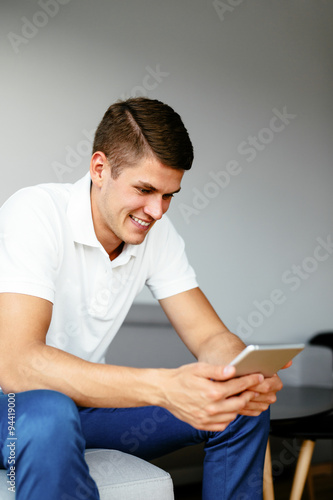 Man at home with digital tablet