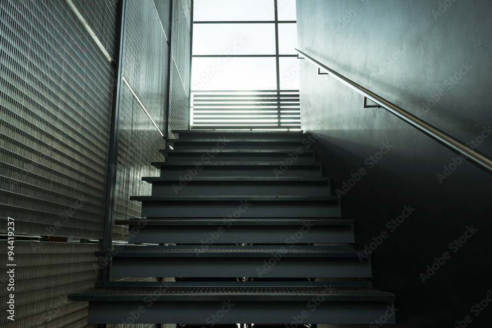 Metal stairs inside building leading window Metal stairs inside building leading window
