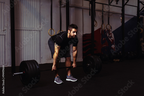 Young man during deadlift exercise