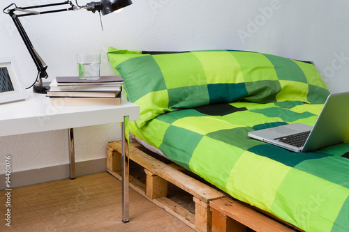 Pallet bed diy in modern bedroom with laptop