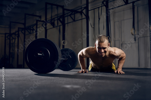Photos Happy man training burpees at gym