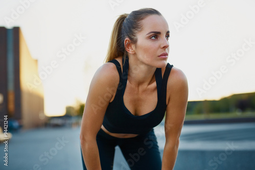 Fototapeta Naklejka Na Ścianę i Meble -  Young woman resting after running exercise