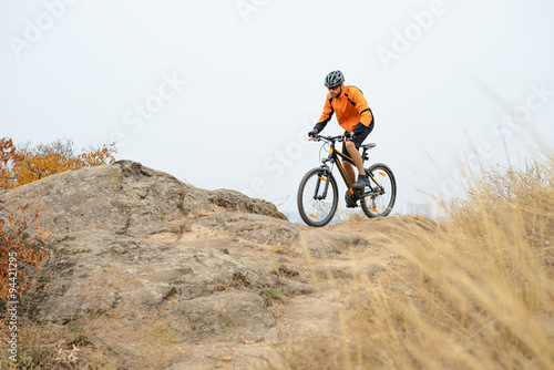 Cyclist Riding Bike on the Beautiful Autumn Mountain Trail