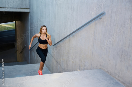 Athletic woman running up stairs during cardio - interval training