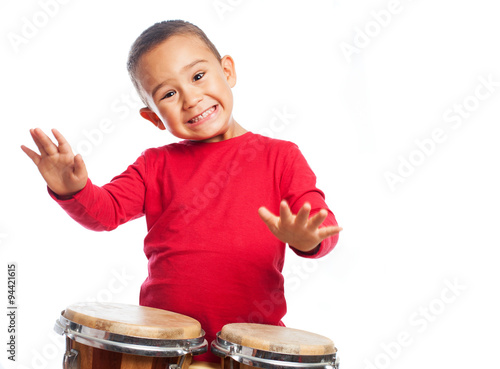 portrait of a little boy playing bongos