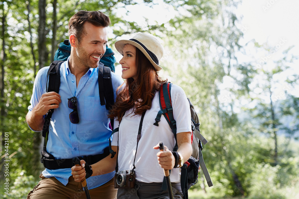 Fototapeta premium Happy backpackers couple hiking