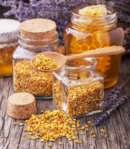 Bee pollen granules and propolis in wooden scoop