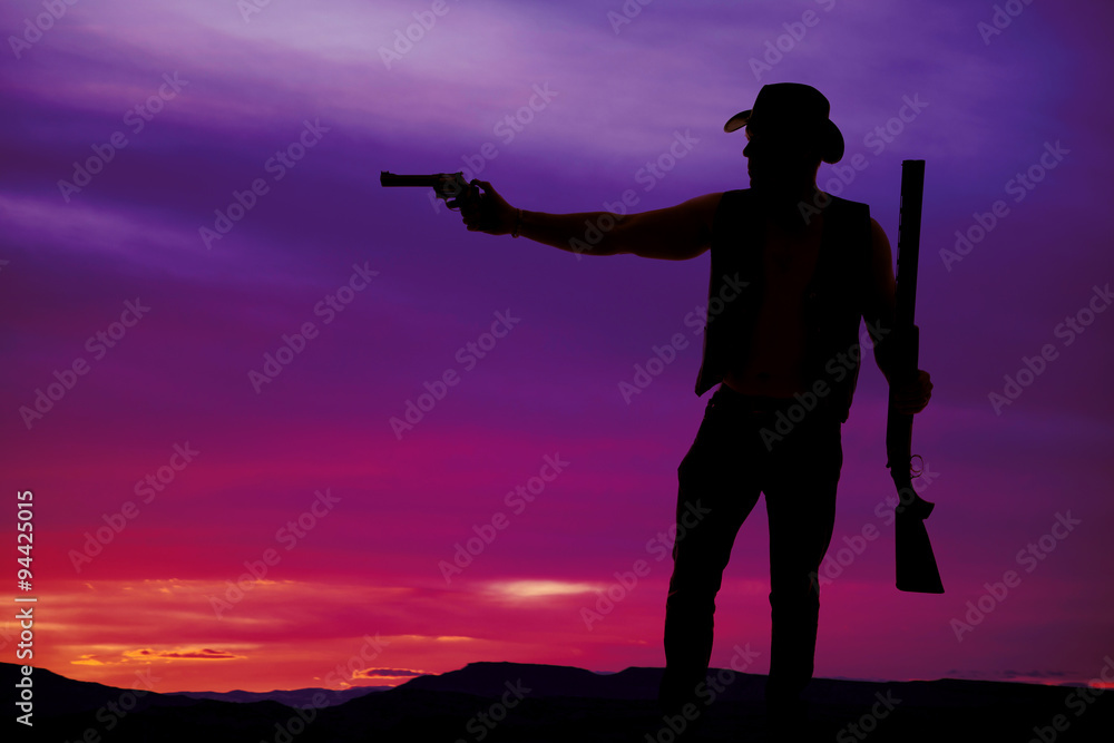 silhouette of a cowboy shotgun in hand pistol pointed silhouette of a cowboy shotgun in hand pistol pointed