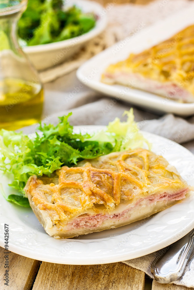 Puff pastry pasty with bechamel sauce, ham and cheese