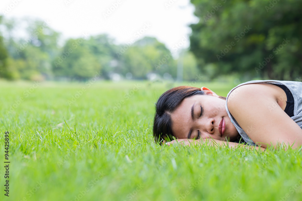 Asian woman sleeping on grass in the park Asian woman sleeping on grass in the park