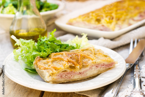 Puff pastry pasty with bechamel sauce, ham and cheese