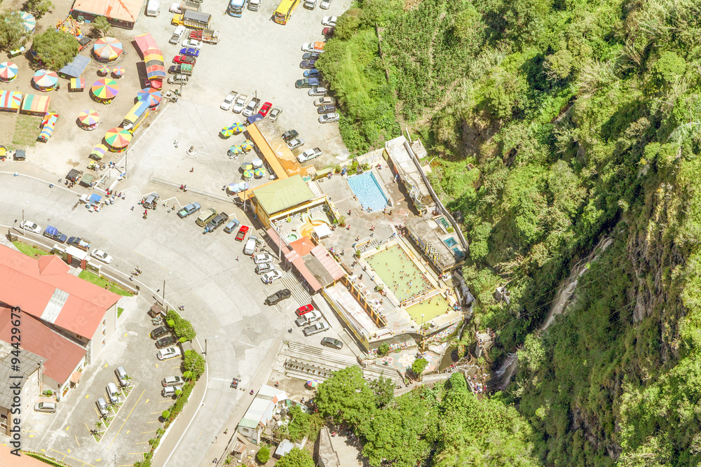 A breathtaking aerial vertical shot captures the stunning beauty of a touristic complex in Baños de Agua Santa,offering a mesmerizing view from high altitude.