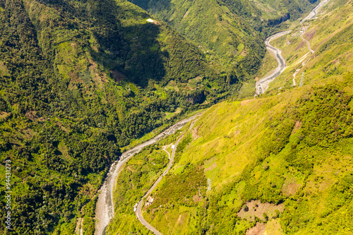 An aerial view of the lush South American jungle, with a meandering river cutting through the breathtaking landscape. AerialAmerica JungleRiver photo