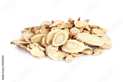 Chinese Herbal medicine - Astragalus slices, Huang Qi (Astragalus propinquus) on white background (manual focus)  photo