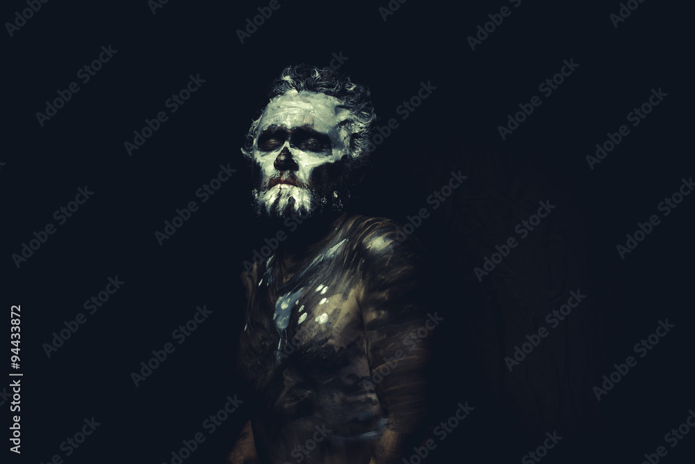 Zulu, wild man with white painted face and full body black paint