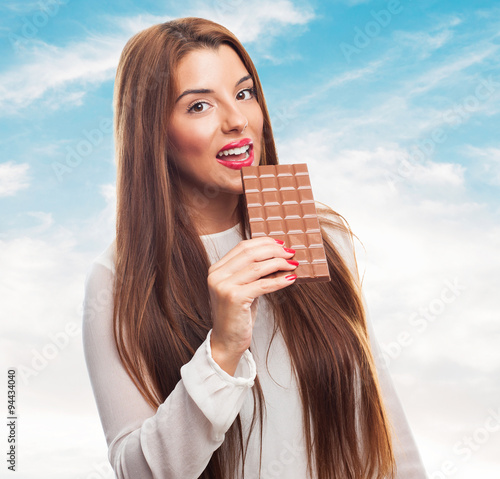portrait of young woman holding a chocolate bar