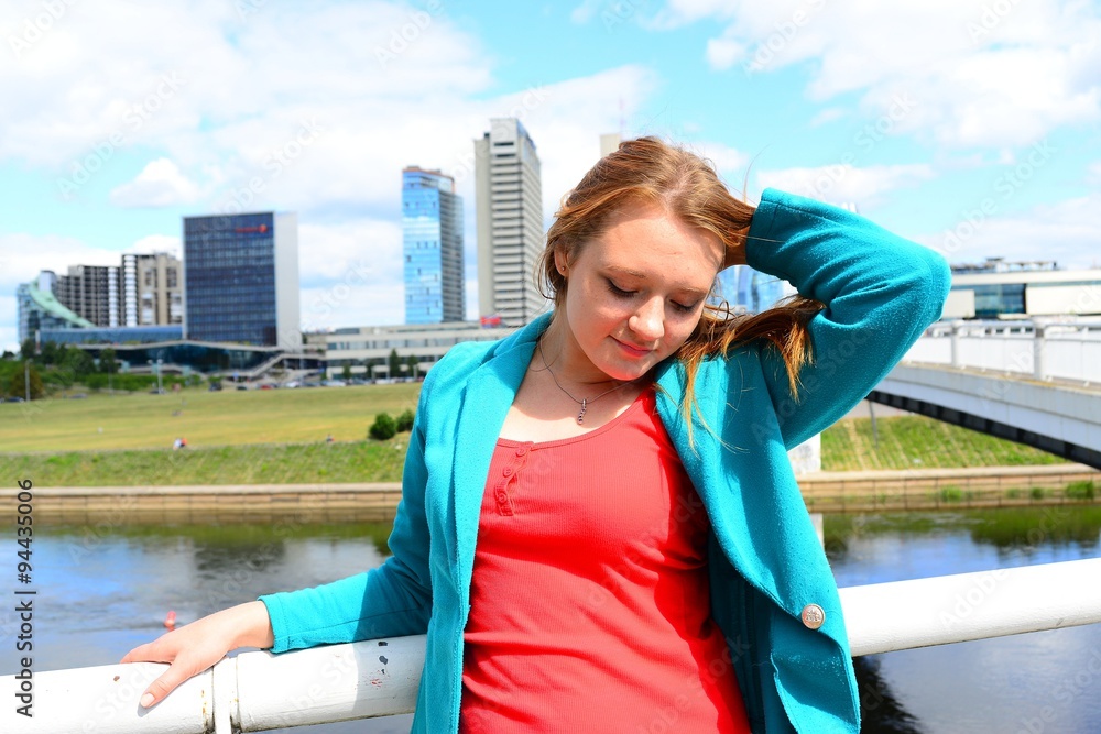 A girl in the city and blue sky and clouds background