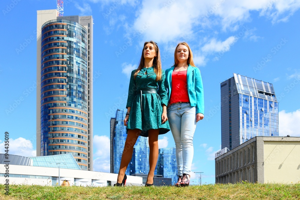 Two girls in blue sky and clouds background