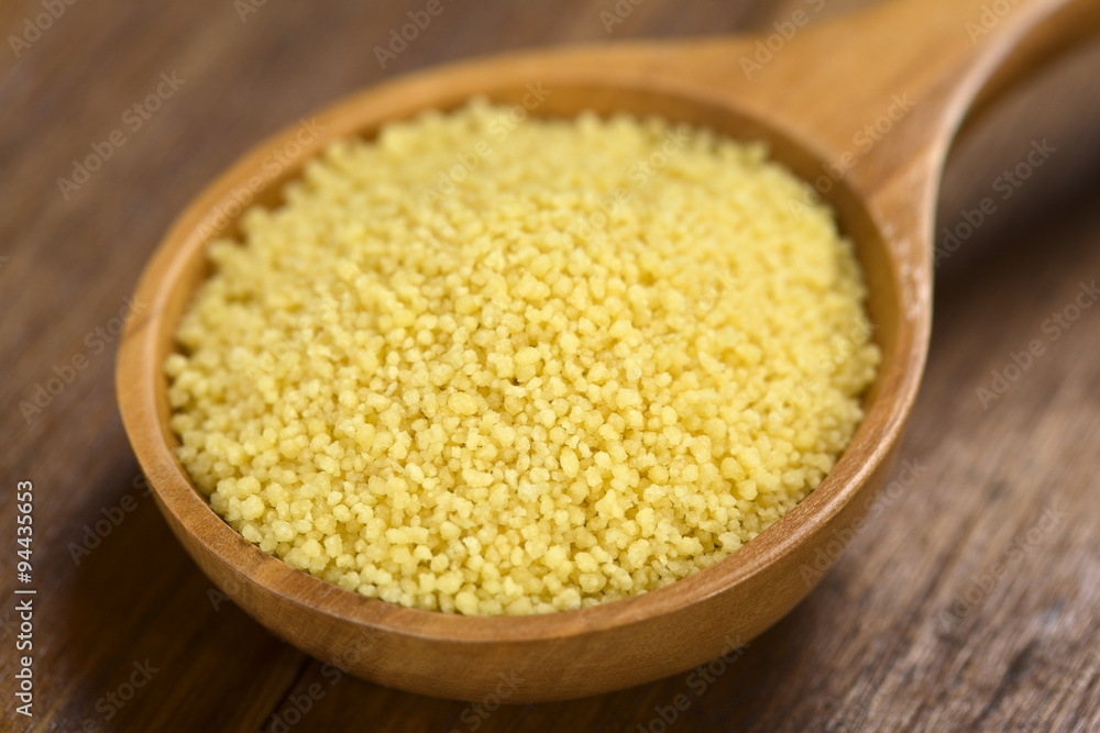 Raw couscous on wooden spoon (Very Shallow Depth of Field, Focus one third into the couscous) Raw couscous on wooden spoon (Very Shallow Depth of Field, Focus one third into the couscous)