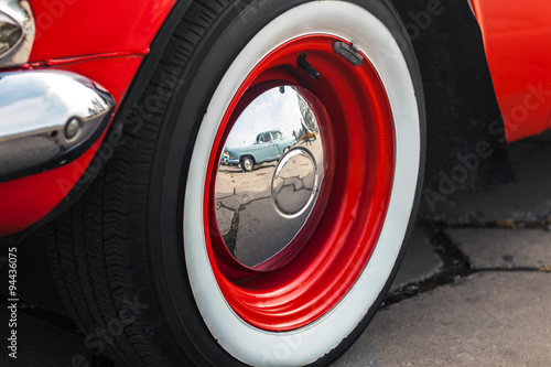 Wheel of retro cars with chrome cap photo