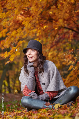 Happy young girl in park on a fall day