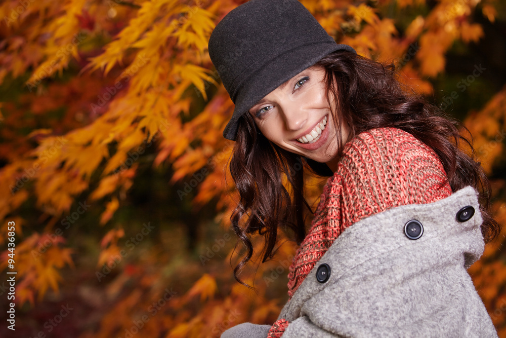 Young woman with autumn leaves in hand and fall yellow maple gar Young woman with autumn leaves in hand and fall yellow maple gar