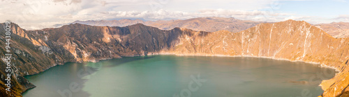 Experience the breathtaking beauty of the Quilotoa Crater Lagoon,nestled in the Ecuadorian Andes,a mesmerizing panorama formed by an inactive volcano.
