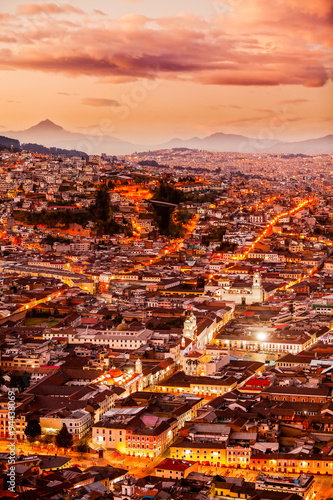 A captivating nocturnal view of Quito, Ecuador's historic capital city, showcasing its stunning landscape with illuminated buildings.