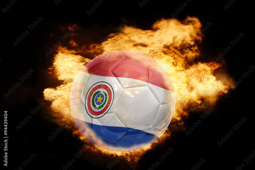 Fototapeta premium football ball with the flag of paraguay on fire