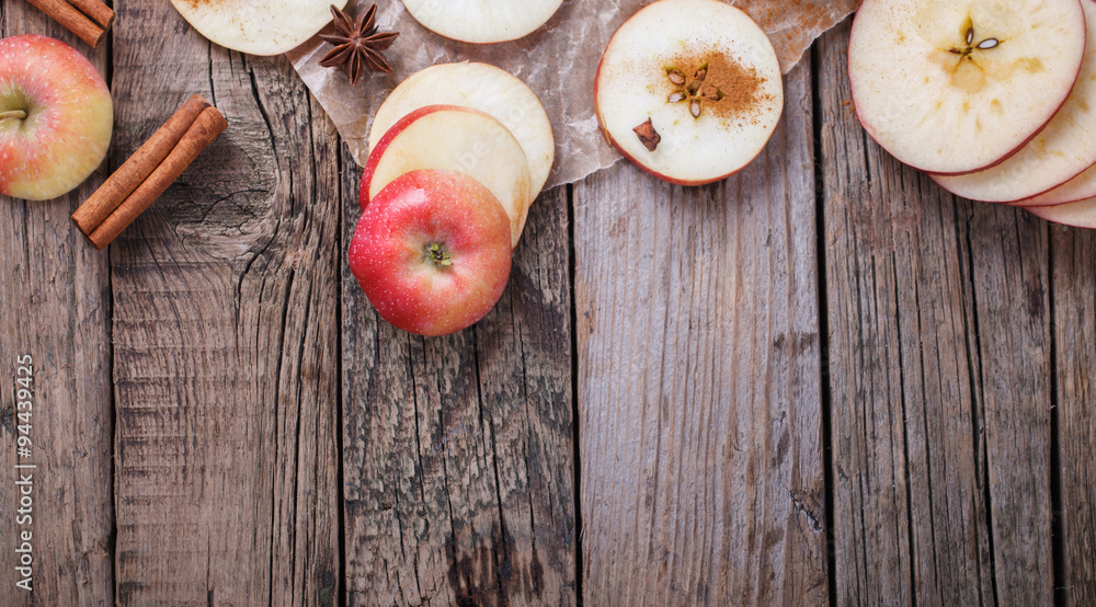 Apples sliced with cinnamon on old wooden background.Copy space.selective focus.